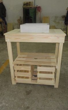 a table made out of wooden pallets in a garage with one drawer open and the other closed