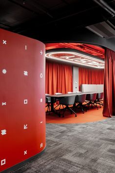 a conference room with red curtains and white tables