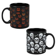 two black coffee mugs decorated with skulls and pumpkins