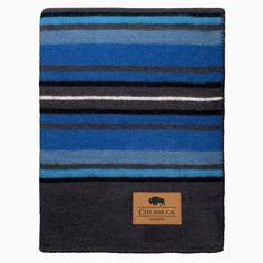 a blue and black striped blanket with a brown tag on the bottom that says, chumback