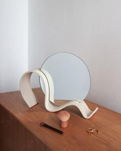 a wooden table with a mirror and other items on it