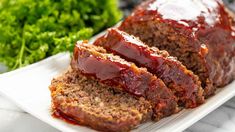 meatloaf on a plate with ketchup and lettuce next to it