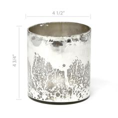 a silver vase sitting on top of a white table