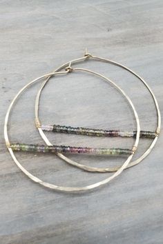 two gold hoop earrings with multicolored beads