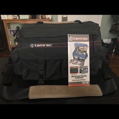 a camera bag sitting on top of a wooden table next to a package with an ad for camrac