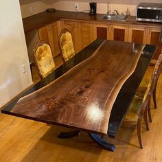 a wooden table sitting in the middle of a kitchen