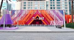 the entrance to salt in front of a building with palm trees and buildings behind it