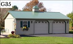 a two car garage with a green roof