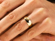 a man and woman's hands with wedding rings