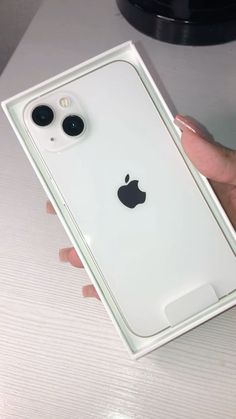 a person holding an iphone in their hand with the back cover removed from its case