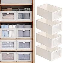 three white bins are stacked on top of each other in front of a wooden shelf