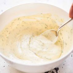 a white bowl filled with dip and a spoon