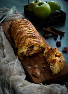 an apple pie is cut in half on a cutting board