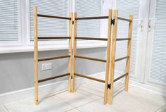 two wooden shelves sitting next to each other in front of a window with shutters