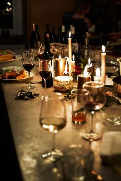 a table topped with wine glasses and candles