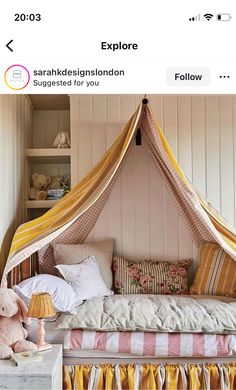 an image of a bed with a canopy and pillows on it's headboard