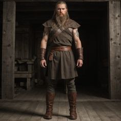 a man with long hair and beard wearing a brown outfit standing in a dark room