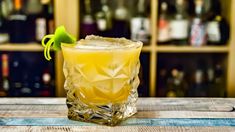 a yellow drink sitting on top of a wooden table