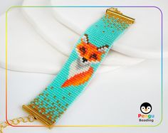 a beaded bracelet with a fox on it and a gold chain hanging from the clasp