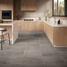 a kitchen with grey tile flooring and wooden cabinets