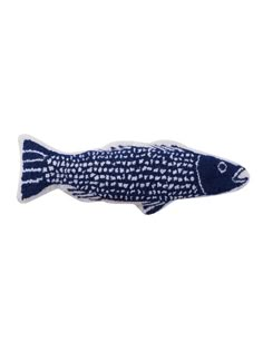 a blue and white fish pillow on a white background