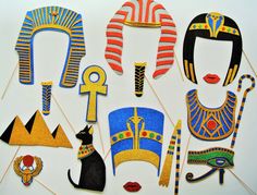 an assortment of egyptian masks and decorations