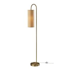 a floor lamp with a beige shade on the base and a white light behind it