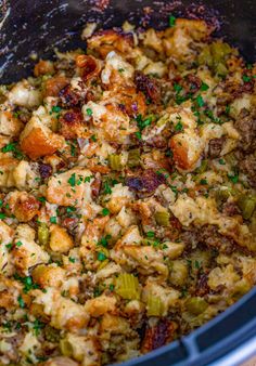 the food in the slow cooker is mixed with other ingredients and has been cooked