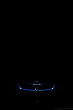 the front end of a car with blue lights on it's hood in the dark