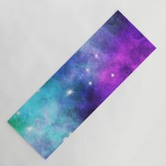 a purple and blue space themed placemat on a white surface with stars in the background