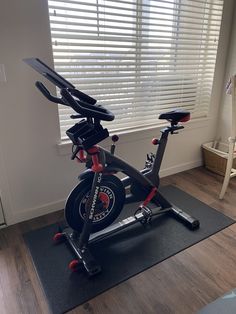 an exercise bike in front of a window with blinds