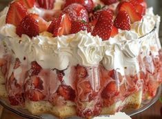 a cake with strawberries and whipped cream on top