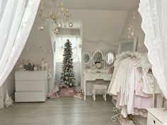 a bedroom with white furniture and christmas tree in the corner on the far wall is a dressing room