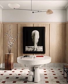 a bathroom with a pedestal sink and large painting on the wall above it's head