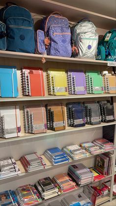 the shelves are filled with books and backpacks