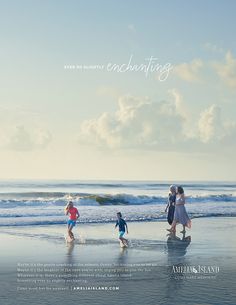 three people walking on the beach with their children