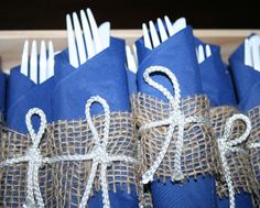 blue napkins wrapped in burlap and tied with twine