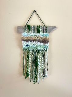 a wall hanging made out of wood and beads