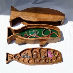 two wooden boxes with beads and necklaces in them