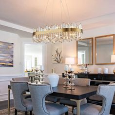 a dining room table with chairs and a chandelier