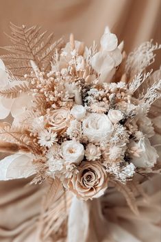 a bridal bouquet with white and peach flowers