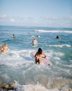 several people in the ocean with surfboards