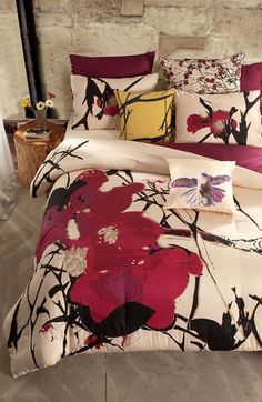 a bed with red and black flowers on it