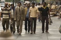 a group of men walking down the street