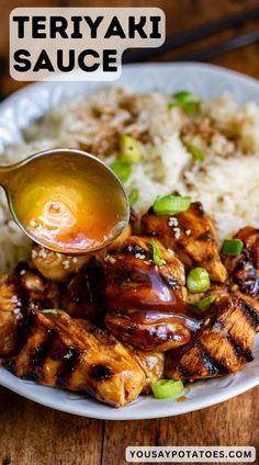 teriyaki sauce being spooned over chicken with rice and green onions on a white plate