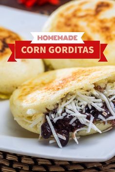 homemade corn gorditass with black beans and cheese on a white platter