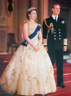 a man and woman in formal dress standing next to each other