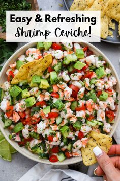 a bowl filled with shrimp and guacamole next to tortilla chips