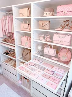 a white closet filled with lots of pink purses and handbags on top of shelves