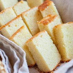 several pieces of cake sitting on top of a white cloth next to some bread sticks